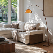 sunset floor lamp beside a modern sofa in a warm living room
