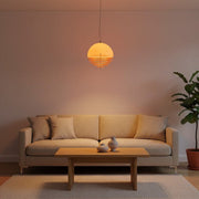 A modern Scandi-minimalist living room featuring a glowing Bauhaus Sunset Pendant Light suspended over a low-profile coffee table.