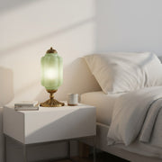 Eloise scallop glass shade vintage table lamp on a modern white nightstand in a minimalist bedroom.