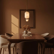 Maillard style dining room featuring the Vintage Glass Eloise Pendant Lamp with warm earth tones.