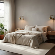 Modern bedroom featuring space-saving wall sconces on either side of the bed