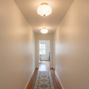 Three Retro Milk Semi Flush Mount Eloise Ceiling Lights installed in a row in a narrow hallway creating visual rhythm.