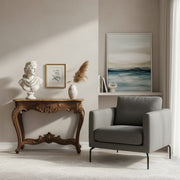 Elegant Parisian apartment living room with ornate moldings and a vintage cream wall sconce.