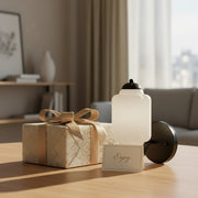 A unique housewarming gift: A beautifully packaged Eloise milk glass wall sconce with a card.