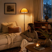 Sunset floor lamp creating warm portrait lighting in a cozy living room