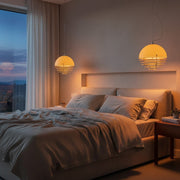 Bauhaus Sunset Pendant Light hanging in a modern bedroom with warm amber glow.