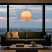 Warm, intimate mood lighting created by the Bauhaus Sunset Pendant Light in a modern living room.