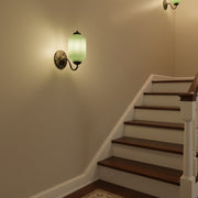 lluminated wooden staircase with vintage wall sconces providing safe and decorative lighting.
