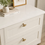 Load image into Gallery viewer, Antique brass handles installed on white drawers