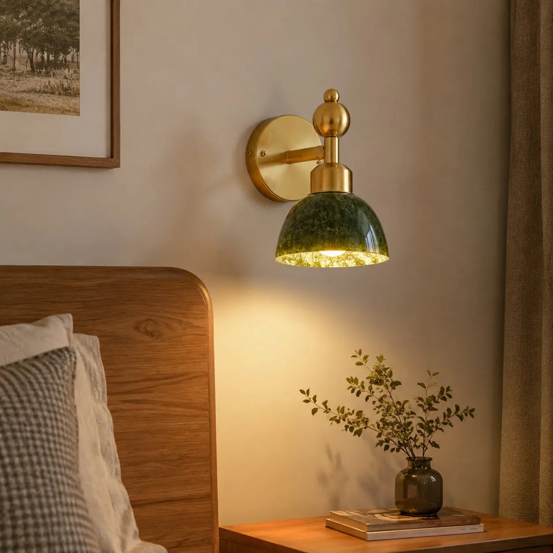Green stone wall light installed beside a bed