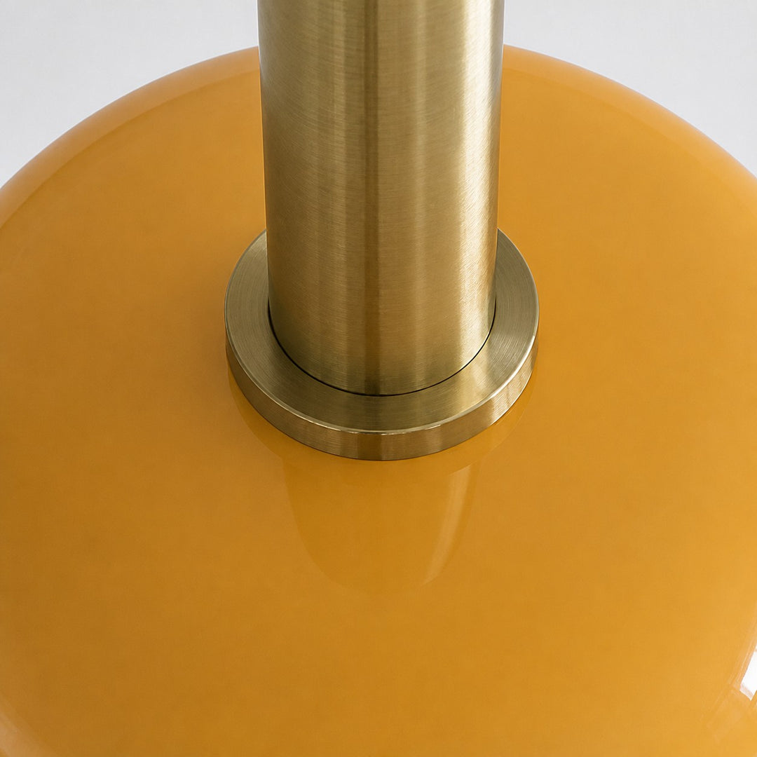 Close view of the brass metal holder and yellow glass shade connection