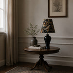 Load image into Gallery viewer, Black floral table lamp in room setting