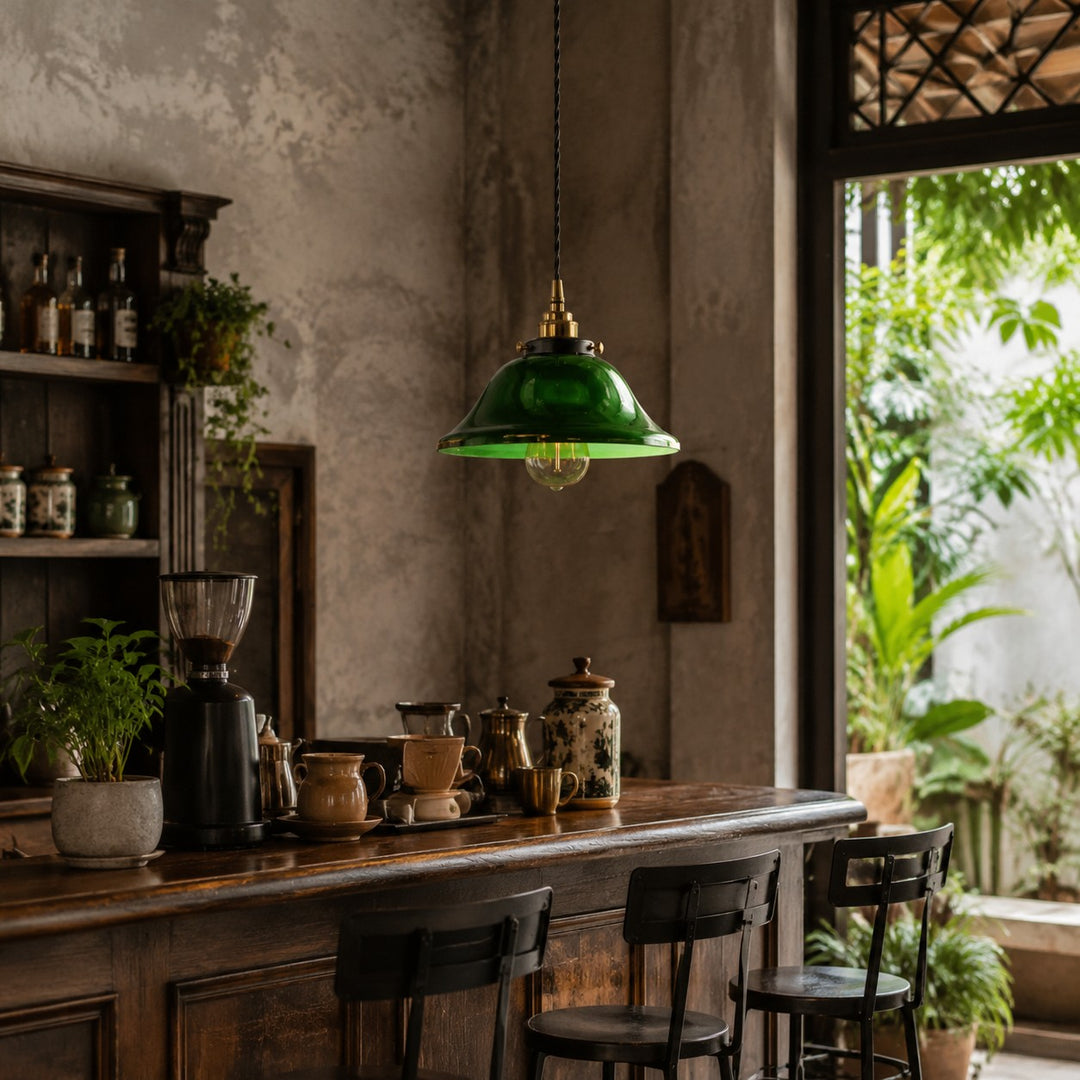 Green glass pendant light above a vintage cafe counter