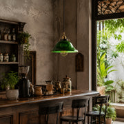 Green glass pendant light above a vintage cafe counter