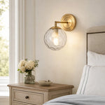 Load image into Gallery viewer, Rippled glass wall lamp above a wood bedside table