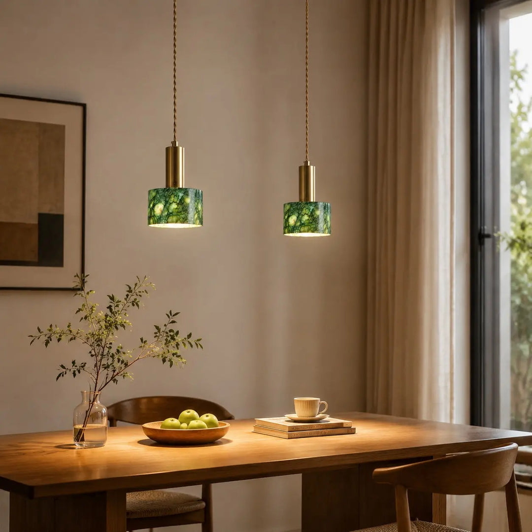 Pair of regular jade pendants in a warm dining room
