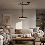 Load image into Gallery viewer, Black movable pendant light in a cozy living room