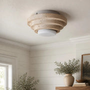 Beige travertine flush mount ceiling light in a bright interior