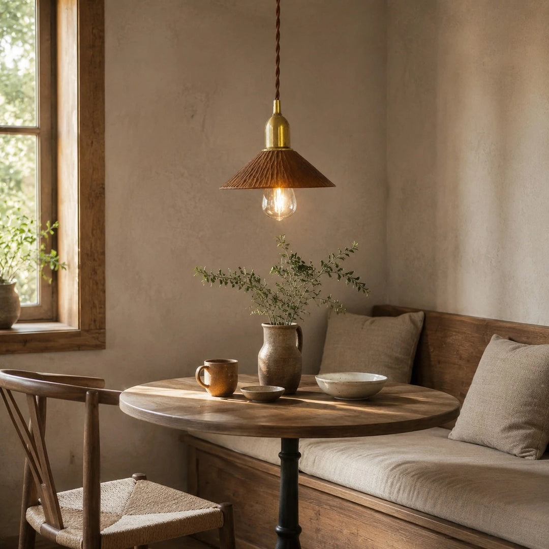 Cherry wood pendant light above a compact dining nook