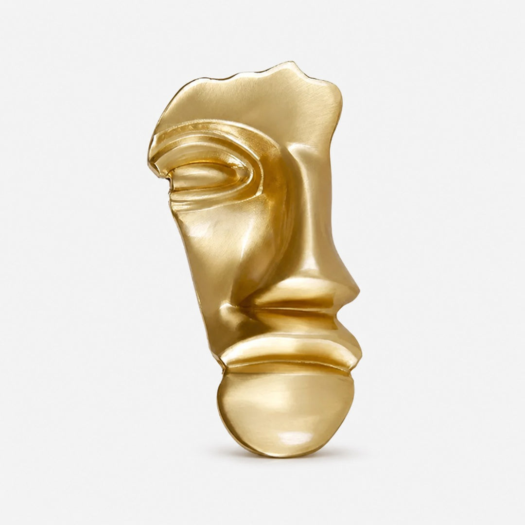 Brass gold abstract face cabinet knob on a clean background