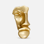 Brass gold abstract face cabinet knob on a clean background