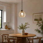 Load image into Gallery viewer, clear glass brass pendant light installed above a small dining table