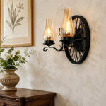 Cargar imagen en el visor de la Galería, Black one-head wagon wheel wall sconce above a wood console
