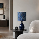 Load image into Gallery viewer, Blue gold fabric ceramic table lamp on a side table