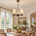 Load image into Gallery viewer, Three-light Hour Rho chandelier in a dining room
