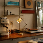 Load image into Gallery viewer, Cream floral table lamp lit on a desk beside coffee and record equipment