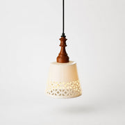 cutout ceramic shade pendant light on gray background