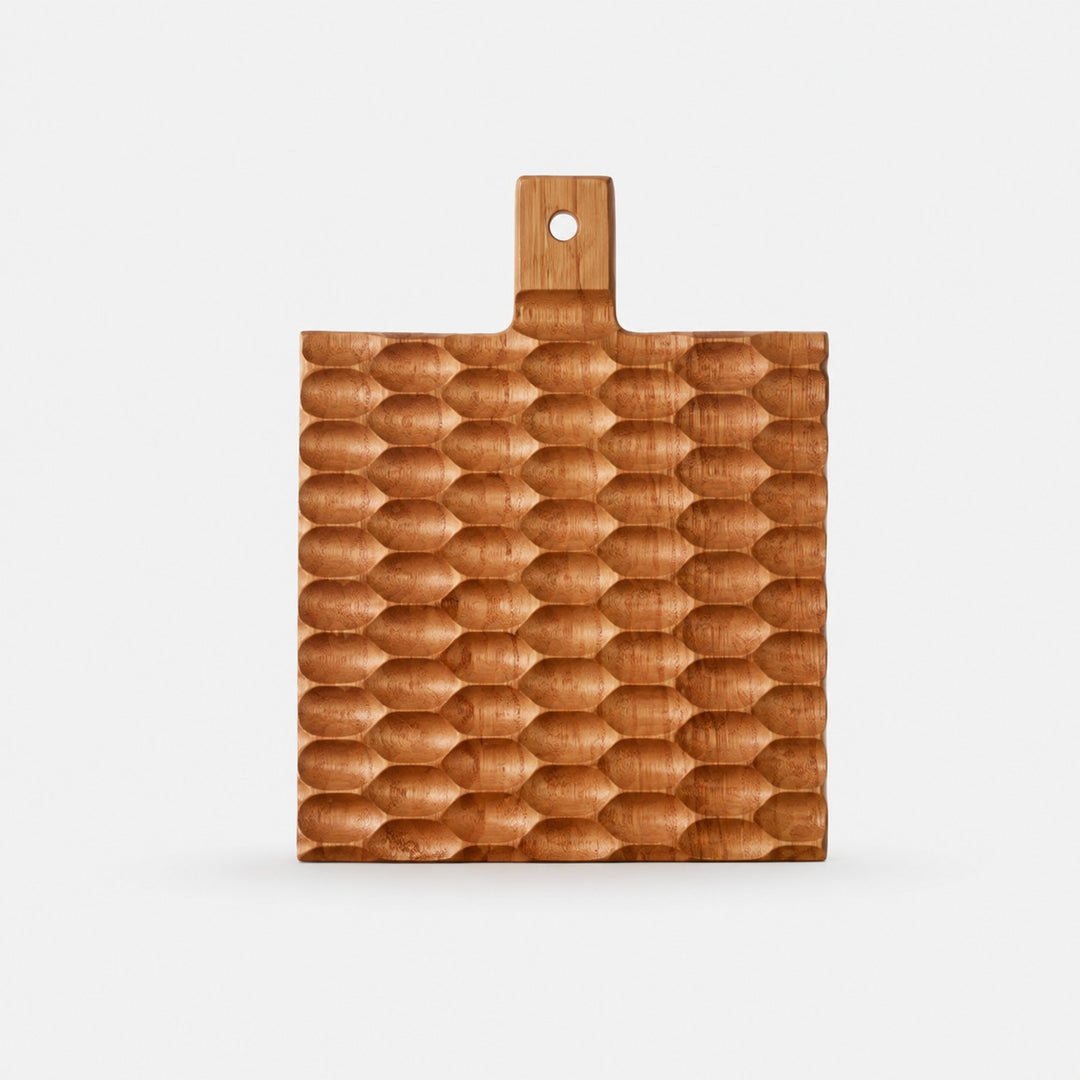 Small cherry wood textured serving board on a light background