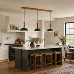 Load image into Gallery viewer, Deep green three-light pendant over a kitchen island