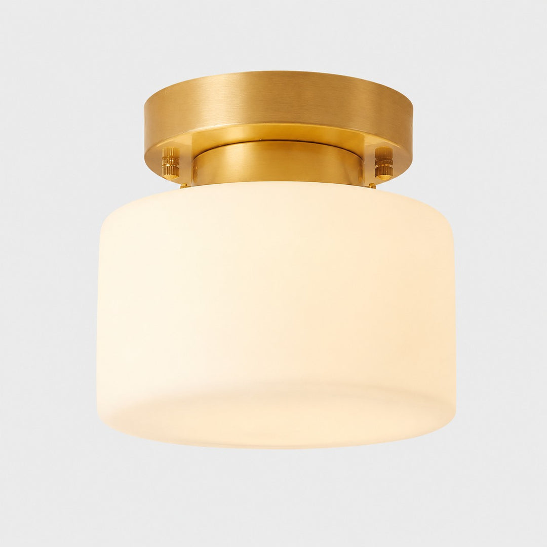 Brass flush mount ceiling light with warm white glass shade