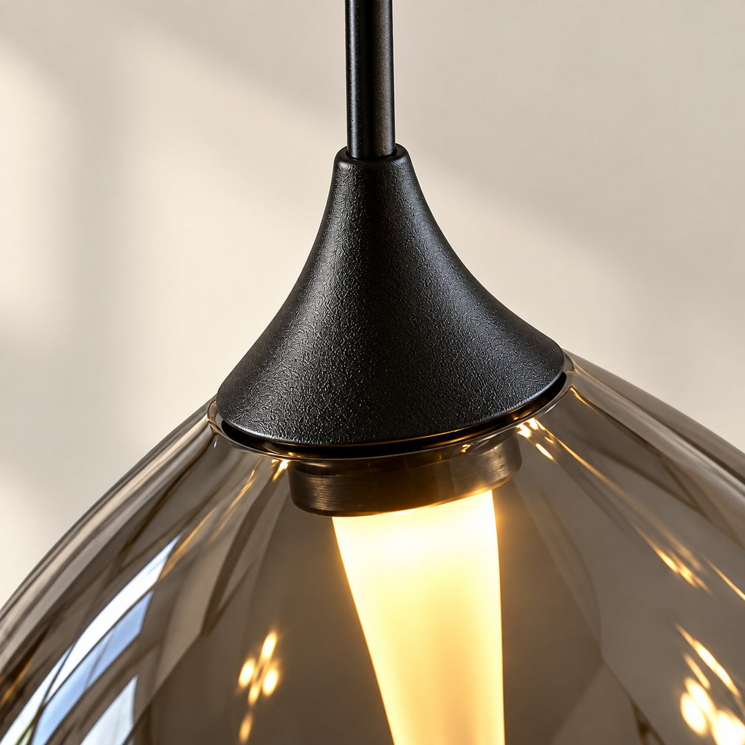 Black metal cap where the cable meets the glass shade