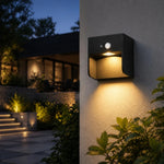 Cargar imagen en el visor de la Galería, Style D black outdoor wall lamp with warm downlight on exterior wall