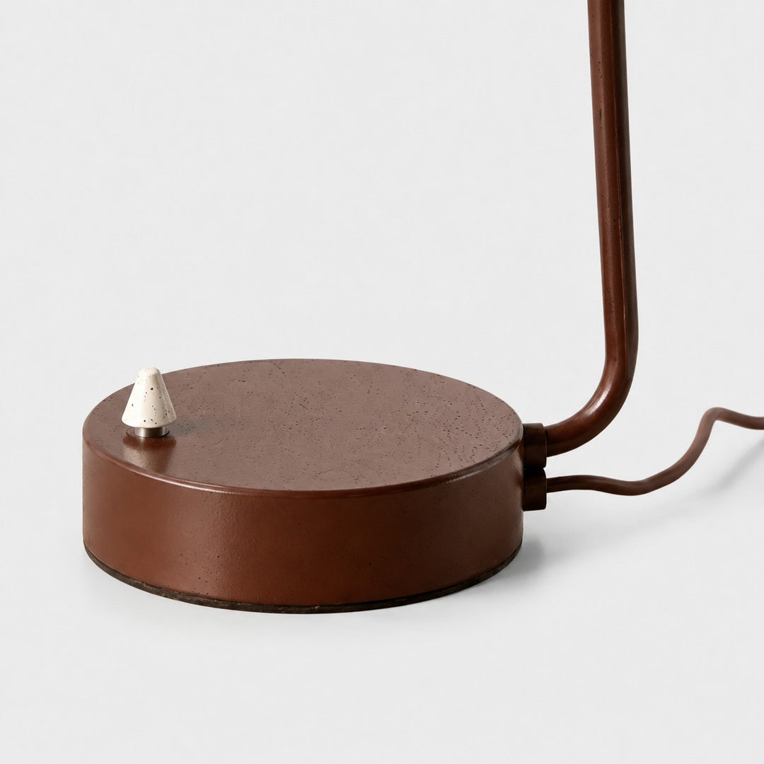 Close-up of brown round lamp base and metal on-off switch