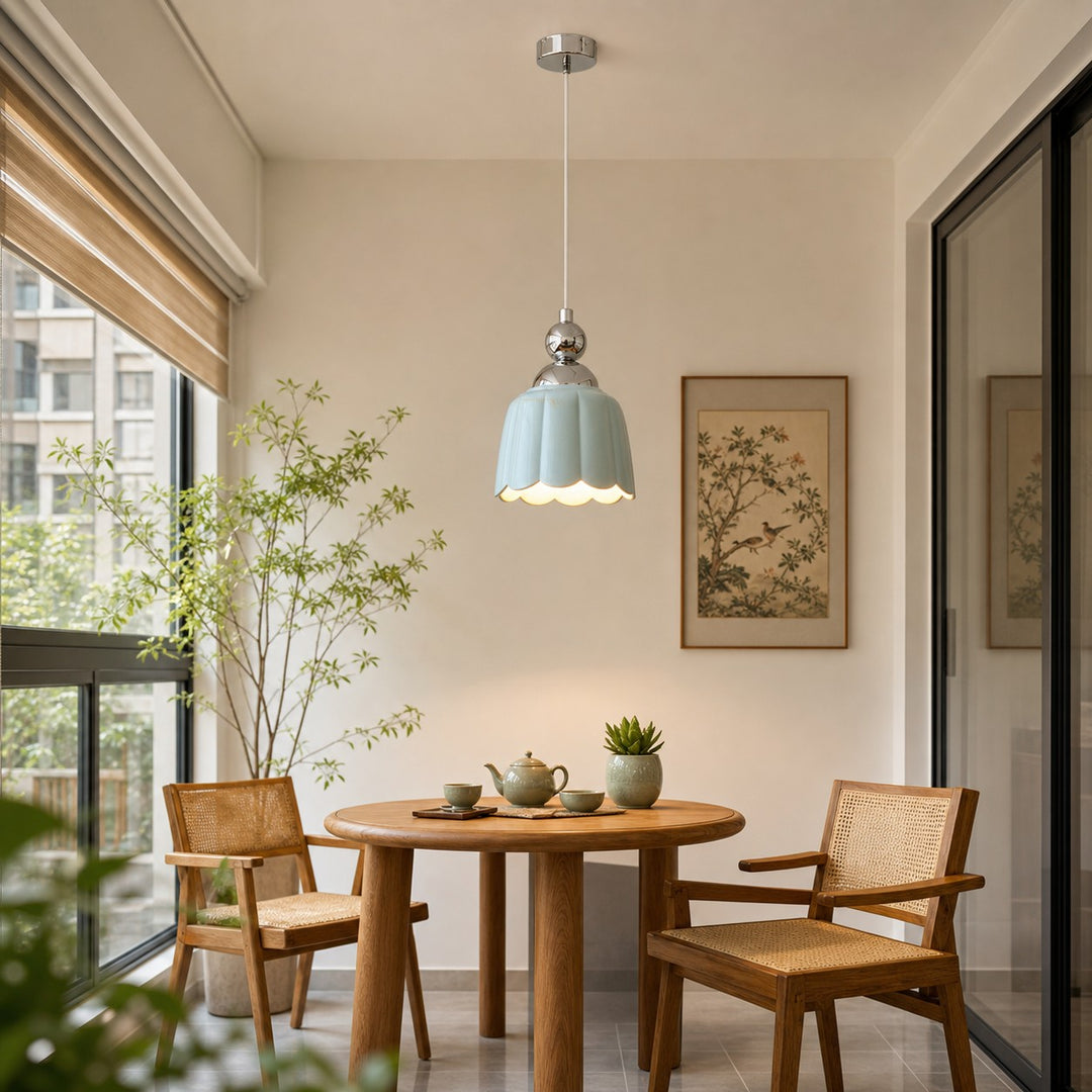 Sea salt blue ceramic pendant lamp above a small dining table