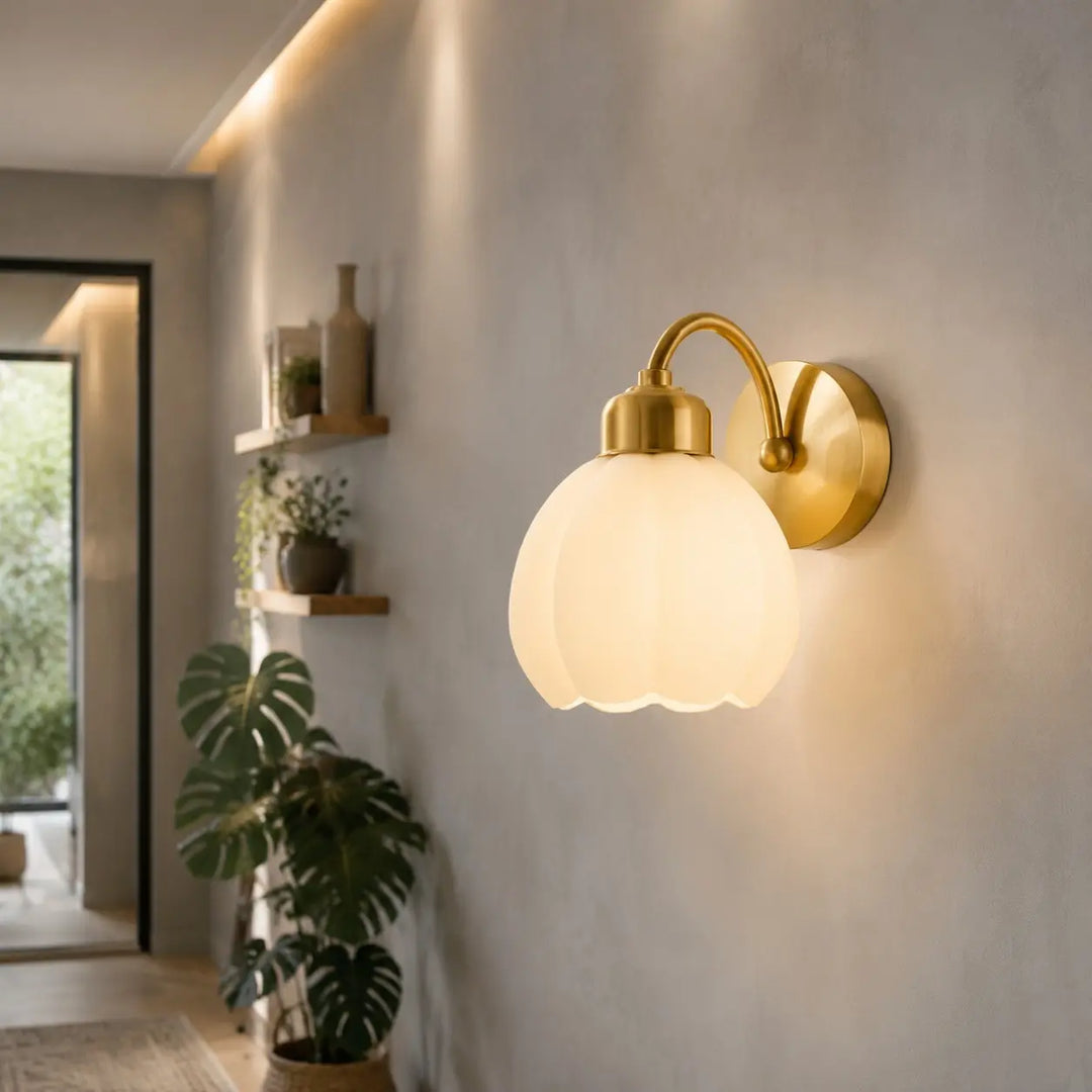Milk glass flower wall lamp illuminating a hallway
