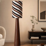 Bild in Gallery-Viewer laden, Tall striped shade floor lamp beside a console table