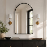 Cargar imagen en el visor de la Galería, pair of natural brass leather wall sconces beside an arched mirror