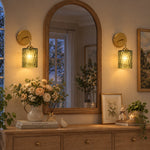 Cargar imagen en el visor de la Galería, Green hammered-glass sconces on a wood console, lights on
