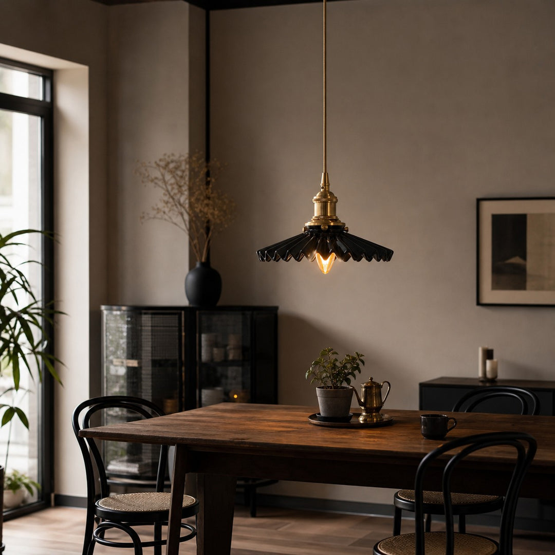 Black ceramic pendant light over a dining table