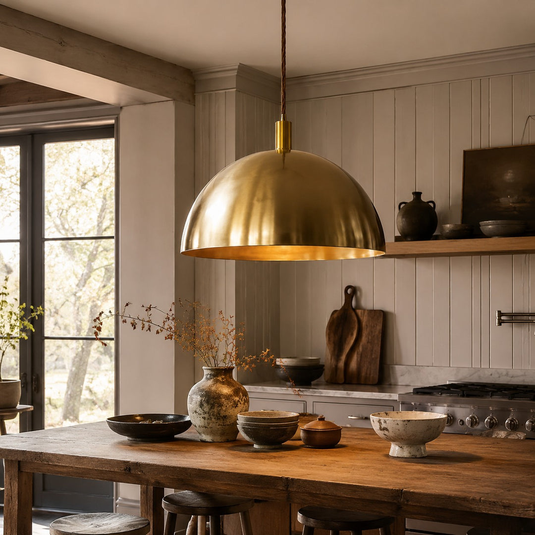 Half dome brass pendant light above a dining corner
