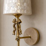 Bild in Gallery-Viewer laden, Detailed view of the shell shade, metal bow and travertine backplate