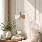 Load image into Gallery viewer, Leather petal pendant light beside a soft upholstered bed