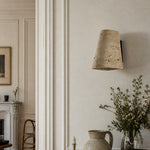 Cargar imagen en el visor de la Galería, Travertine wall sconce installed in a refined dining interior