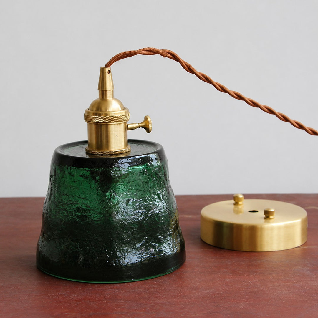 Green hammered glass pendant light with brass-tone canopy