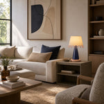 Load image into Gallery viewer, Sculptural ceramic table lamp beside a neutral sofa