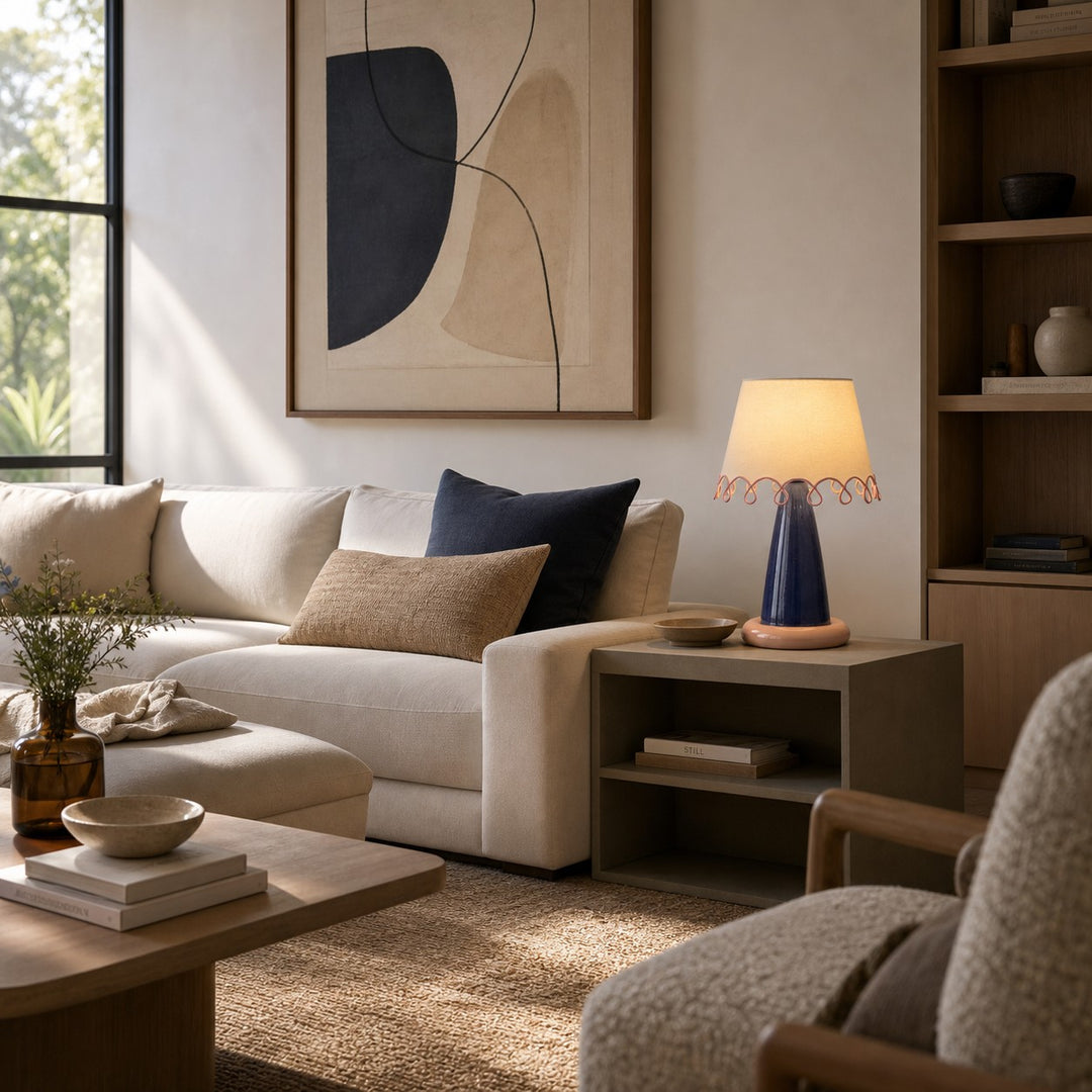 Sculptural ceramic table lamp beside a neutral sofa